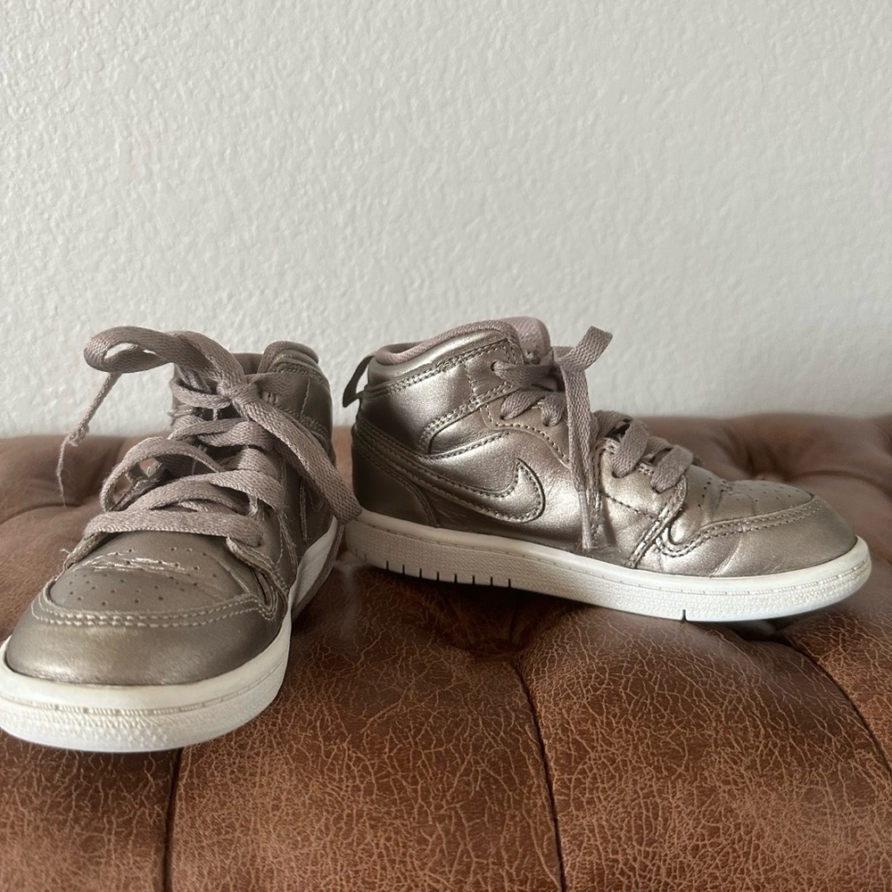 Kids Nike Air Jordans in metallic bronze